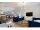 Open living room and kitchen with blue sofa and hardwood floors at 2321 Lobelia Dr, Lake Mary, FL 32746