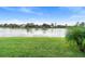 Serene backyard view overlooking a lake with lush greenery at 2626 Raccoon Run Ln, Orlando, FL 32837