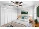 Bright bedroom with a queen-size bed, built-in closet, and window shutters at 2626 Raccoon Run Ln, Orlando, FL 32837