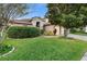 Brick home with lush landscaping and a two-car garage at 2626 Raccoon Run Ln, Orlando, FL 32837