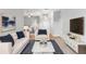Spacious living room with white sofa, large TV, and open floor plan at 2626 Raccoon Run Ln, Orlando, FL 32837