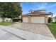 Brick house with two-car garage and paver driveway at 2626 Raccoon Run Ln, Orlando, FL 32837