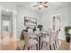 Formal dining room with glass table, neutral decor, and six chairs at 2626 Raccoon Run Ln, Orlando, FL 32837