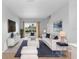 Living room with white sofas, pool view, and stylish decor at 2626 Raccoon Run Ln, Orlando, FL 32837