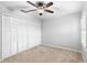 Well-lit bedroom with double door closet and ceiling fan at 2626 Raccoon Run Ln, Orlando, FL 32837