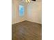 Second bedroom with wood-look tile floors and large window at 3468 Soho St # 107, Orlando, FL 32835