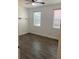 Bright bedroom featuring wood-look tile floors and neutral walls at 3468 Soho St # 107, Orlando, FL 32835