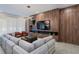 Spacious living room with sectional sofa and wood accent wall at 5937 High Seas Dr, Orlando, FL 32821