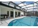Outdoor oasis featuring a pool, spa, and an outdoor kitchen at 5937 High Seas Dr, Orlando, FL 32821
