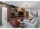 Modern living room with sectional sofa, wood feature wall, and large TV at 5937 High Seas Dr, Orlando, FL 32821