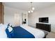 Bright bedroom with a king-size bed, TV, and access to bathroom at 5937 High Seas Dr, Orlando, FL 32821