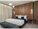 Spacious primary bedroom with wood-paneled accent wall and plush bedding at 5937 High Seas Dr, Orlando, FL 32821