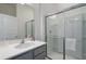 Simple bathroom with gray vanity, a shower, and white tile at 5937 High Seas Dr, Orlando, FL 32821