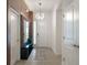 Bright and spacious entryway with modern wood wall and mirror at 5937 High Seas Dr, Orlando, FL 32821