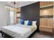 Modern bedroom with dark-paneled accent wall and cozy bedding at 5937 High Seas Dr, Orlando, FL 32821