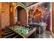 Fun game room with foosball table, mural, and plenty of space for entertainment at 5937 High Seas Dr, Orlando, FL 32821