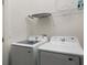 Bright laundry room with Samsung washer and dryer and ample shelving at 5937 High Seas Dr, Orlando, FL 32821
