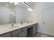 Modern bathroom with double vanity, gray cabinets, and a large mirror at 5937 High Seas Dr, Orlando, FL 32821