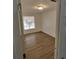 Well-lit bedroom featuring wood-look floors and a large window at 6008 Village Cir # Ge, Orlando, FL 32822