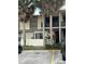 Condo building with palm trees and parking lot in front at 6008 Village Cir # Ge, Orlando, FL 32822