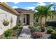 Landscaped entryway with a brick path leading to the front door at 120 Vizcaya Ct, Poinciana, FL 34759