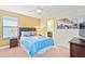 Bedroom with a queen bed, nightstands and a view into the ensuite bathroom at 1423 Thunderbird Rd, Davenport, FL 33896