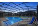 Relaxing screened-in pool and spa area with lounge chairs at 1423 Thunderbird Rd, Davenport, FL 33896