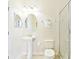Clean bathroom with pedestal sink, toilet and shower at 1423 Thunderbird Rd, Davenport, FL 33896