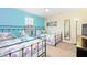 Bedroom with two twin beds, featuring a teal and white color scheme at 1423 Thunderbird Rd, Davenport, FL 33896