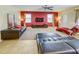 Living room with comfortable leather seating and a large TV at 1423 Thunderbird Rd, Davenport, FL 33896