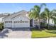 Two-story house with three-car garage and stone accents at 1490 Olympic Club Blvd, Champions Gate, FL 33896