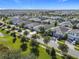 Aerial view of a street lined with houses at 1490 Olympic Club Blvd, Champions Gate, FL 33896