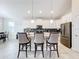 Modern kitchen with white cabinets, a large island, and stainless steel appliances at 1490 Olympic Club Blvd, Champions Gate, FL 33896