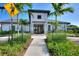 Modern community center with palm trees and walkway at 1490 Olympic Club Blvd, Champions Gate, FL 33896