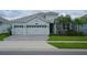 Two-story house with three-car garage and stone accents at 1490 Olympic Club Blvd, Champions Gate, FL 33896