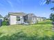Backyard view showcasing home and screened patio at 1490 Olympic Club Blvd, Champions Gate, FL 33896
