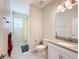 Bathroom with tub and shower, single vanity, and yellow curtain at 1490 Olympic Club Blvd, Champions Gate, FL 33896