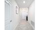 Light and airy hallway with tile floors, and neutral walls at 1490 Olympic Club Blvd, Champions Gate, FL 33896
