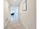 Bright hallway with tile flooring and views into the living area at 1490 Olympic Club Blvd, Champions Gate, FL 33896
