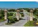 Grand entrance to ChampionsGate, featuring decorative pillars and landscaping at 1490 Olympic Club Blvd, Champions Gate, FL 33896