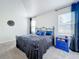 Spacious primary bedroom with king-size bed, dark blue bedding and a blue dresser at 1490 Olympic Club Blvd, Champions Gate, FL 33896