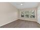 Well-lit bedroom with wood-look floors and three windows at 1921 Stockton Dr, Sanford, FL 32771