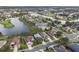 Aerial view of homes surrounding a lake in a residential community at 2018 Bayside Ave, Mount Dora, FL 32757