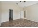 Well-lit bedroom with wood-look floors and access to bathroom at 235 Royal Palm Dr, Davenport, FL 33837