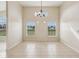 Spacious dining room with tile flooring and a chandelier at 235 Royal Palm Dr, Davenport, FL 33837