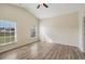 Bright bedroom with wood-look floors and two windows at 235 Royal Palm Dr, Davenport, FL 33837