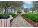 Relaxing community pathway with a stone arch and lush landscaping at 235 Royal Palm Dr, Davenport, FL 33837
