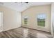 Spacious bedroom featuring wood-look floors and large windows at 235 Royal Palm Dr, Davenport, FL 33837