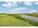 Golf course view with water feature and lush greenery at 235 Royal Palm Dr, Davenport, FL 33837