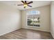 Spacious bedroom with wood-look flooring and an arched window at 235 Royal Palm Dr, Davenport, FL 33837